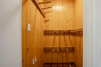 a room with a wooden wall with a staircase at Studio in Market Pavilion, Private Balcony, Common Hot Tub, Epic Village Location, Parking in Whistler