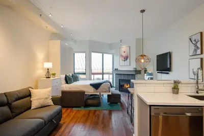 a living room with a couch and a bed at Studio in Market Pavilion, Private Balcony, Common Hot Tub, Epic Village Location, Parking in Whistler
