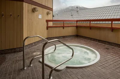 a bath tub in the middle of a room at Studio in Market Pavilion, Private Balcony, Common Hot Tub, Epic Village Location, Parking in Whistler