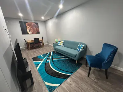 a living room with a couch and two chairs at Cute Highland Park(Upper-A-Unit) in Calgary
