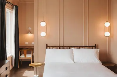 a bedroom with a bed with three lights above it at Hotel Morado in Chilliwack