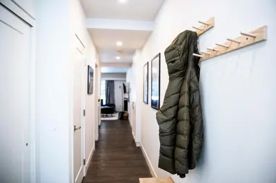 a hallway with a coat hanging on the wall at Absolutely Revy - Ground Level Condo in Revelstoke in Revelstoke
