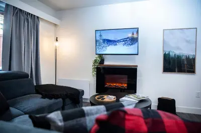 a living room with a couch and a fireplace at Absolutely Revy - Ground Level Condo in Revelstoke in Revelstoke