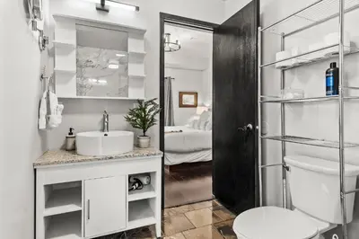 a white bathroom with a sink and a toilet at Luxury 3B Mountain Views- Pool & Hot Tub -Sleeps 10 in Canmore