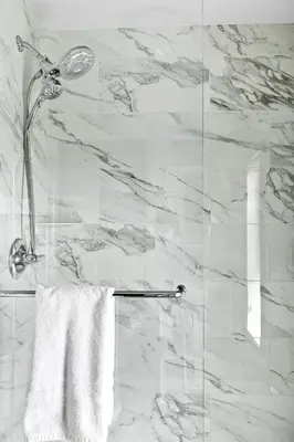 a bathroom with a shower with a white towel at Luxury 3B Mountain Views- Pool & Hot Tub -Sleeps 10 in Canmore