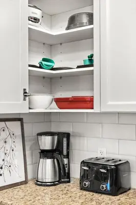 a kitchen counter with a coffee maker in a cupboard at Luxury 3B Mountain Views- Pool & Hot Tub -Sleeps 10 in Canmore