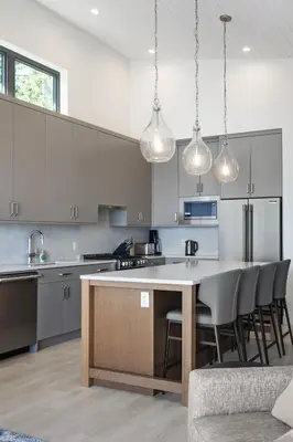 a kitchen with a large island in the middle at Beachfront Luxury Suite #21 at THE BEACH HOUSE in Campbell River