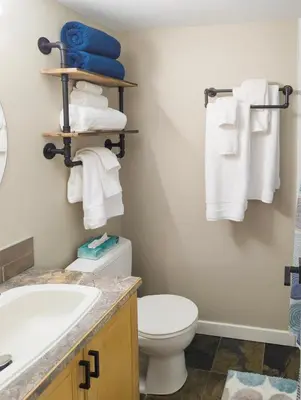 a bathroom with a toilet and a sink and towels at 2 Bedroom and Wall Bed Mountain Getaway Ski In Ski Out Condo with Hot Pools Sleeps 8 in Panorama