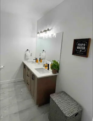 a bathroom with a sink and a mirror at Relaxing 3 bedroom suite, near Silver Star Resort in Vernon