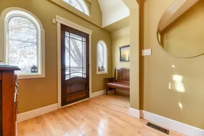 a home with a hallway with a door and windows at First Place in Strathmore