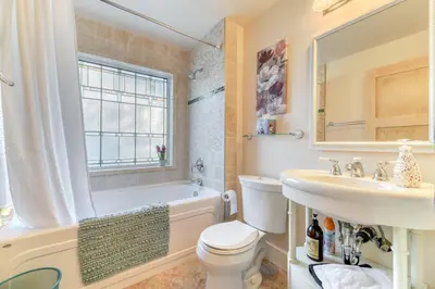 a bathroom with a tub and a sink and a toilet at First Place in Strathmore