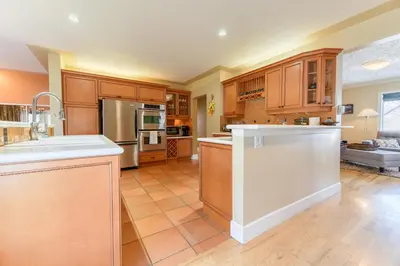 a large kitchen with wooden cabinets and white appliances at First Place in Strathmore