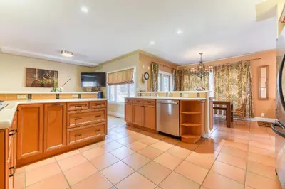 a large kitchen with wooden cabinets and stainless steel appliances at First Place in Strathmore