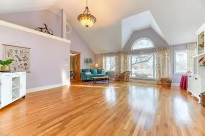 an empty living room with a hard wood floor at First Place in Strathmore