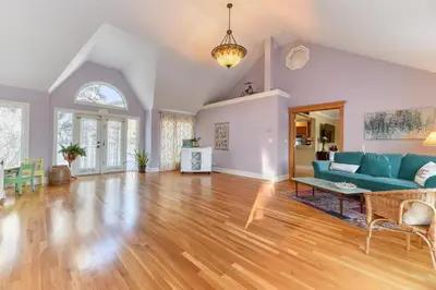 a living room with a blue couch and a table at First Place in Strathmore