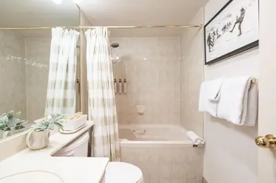 a bathroom with a tub and a toilet and a sink at Foxglove by Outpost Whistler in Whistler