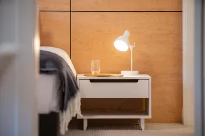 a table with a lamp and a glass on it at Hygge Haus by Revelstoke Vacations in Revelstoke