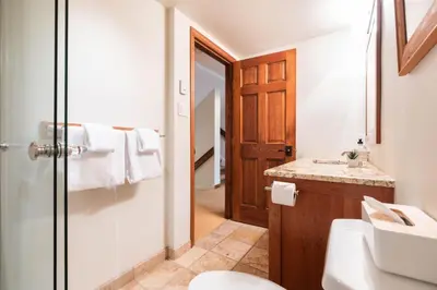 a bathroom with a toilet and a sink at Blackcomb Greens by Outpost Whistler in Whistler