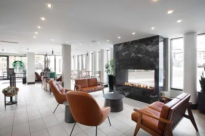 a lobby with a fireplace in a building at DoubleTree by Hilton Hotel & Suites Victoria in Victoria