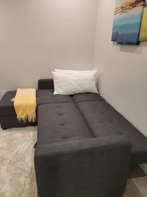 a large bed in a room with a couch at Modern 2 Bed Urban Retreat in Calgary