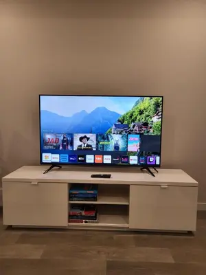 a flat screen tv sitting on top of a entertainment center at Modern 2 Bed Urban Retreat in Calgary