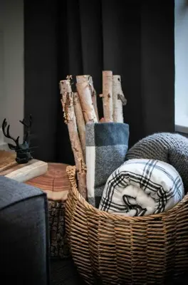 a wicker basket filled with towels and a table at The Eden Whistler - Luxury 2 BDRM Ski in / Ski out in Whistler