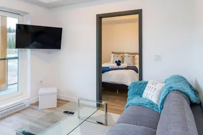 a living room with a couch and a tv and a bed at NN - The Current 2 - Downtown 1-Bed 1-Bath in Whitehorse