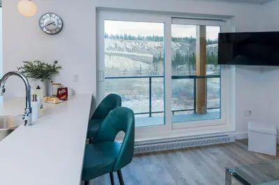 a kitchen with a counter and a large window at NN - The Current 2 - Downtown 1-Bed 1-Bath in Whitehorse