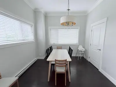 a dining room with a table and chairs and a chandelier at Spacious Home in Richmond in Richmond