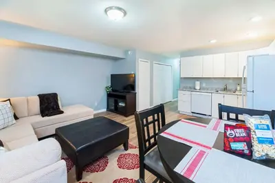 a living room with a couch and a table and a kitchen at NN - The Mack - Crestview 1-bed 1-bath in Whitehorse