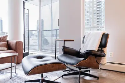 a chair in a room with a large window at Near BC Place & SkyTrain Access & Free Parking in Vancouver