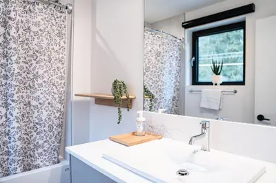 a bathroom with a sink and a mirror at Powder Pines Retreat by Revelstoke Vacations in Revelstoke