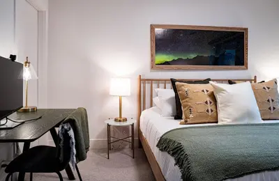a bedroom with a bed and a desk with a desk at Powder Pines Retreat by Revelstoke Vacations in Revelstoke