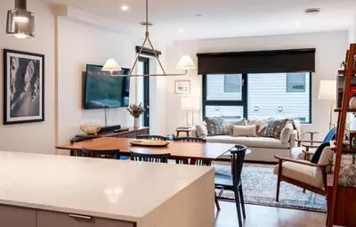 a kitchen and living room with a table and chairs at Powder Pines Retreat by Revelstoke Vacations in Revelstoke