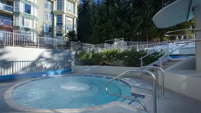 a hot tub on the side of a building at Woodrun Lodge 417 | Ski-In Ski-Out, Pool, Hot Tub, Free Parking in Whistler