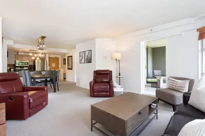 a living room with a couch and a table at Woodrun Lodge 417 | Ski-In Ski-Out, Pool, Hot Tub, Free Parking in Whistler
