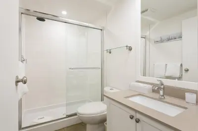 a bathroom with a shower and a toilet and a sink at Woodrun Lodge 414 | Cozy Ski-In Ski-Out Condo w/ Shared Hot Tub, Pool, Fireplace, & Parking in Whistler