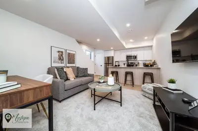 a living room with a couch and a table at Modern Suite King Bed Near Whyte Ave and U of A WIFI in Edmonton