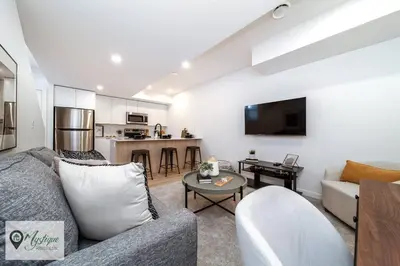 a living room with a couch and a table at Modern Suite King Bed Near Whyte Ave and U of A WIFI in Edmonton