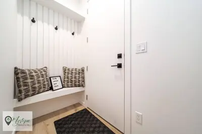 a hallway with a bench and pillows on it at Modern Suite King Bed Near Whyte Ave and U of A WIFI in Edmonton