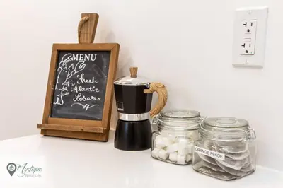 a coffee maker on a counter next to a chalkboard at Modern Suite King Bed Near Whyte Ave and U of A WIFI in Edmonton