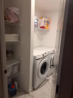 a small laundry room with a washer and dryer at PeaceHouse for females only - Business visits in Calgary