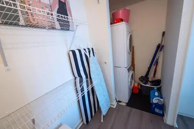 a laundry room with a washer and a washing machine at Modern top-floor 1-bedroom loft with free parking in Vancouver