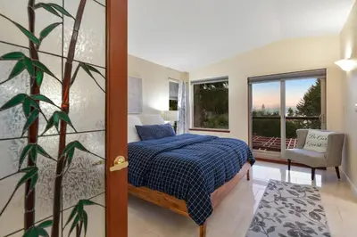 a bedroom with a bed and a window at Dolphin House by EMR Vacation Rentals in Nanoose Bay