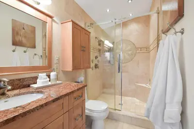 a bathroom with a shower and a toilet and a sink at Dolphin House by EMR Vacation Rentals in Nanoose Bay