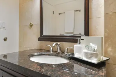 a bathroom counter with a sink and a mirror at Dolphin House by EMR Vacation Rentals in Nanoose Bay