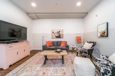 a living room with a couch and a tv at Modern Country Retreat-5 min to DTN-U/G Parking in Edmonton