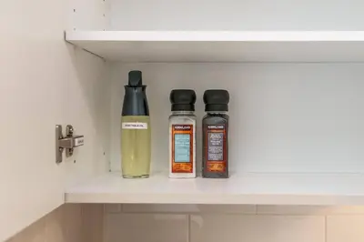 two bottles of liquid sitting on a shelf at Modern Country Retreat-5 min to DTN-U/G Parking in Edmonton