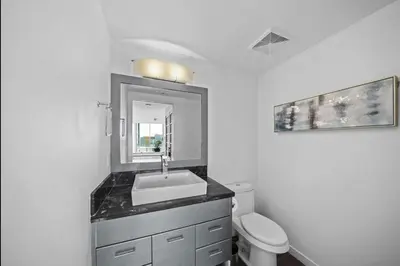 a bathroom with a sink and a toilet at Skyline Hideaway in Vancouver