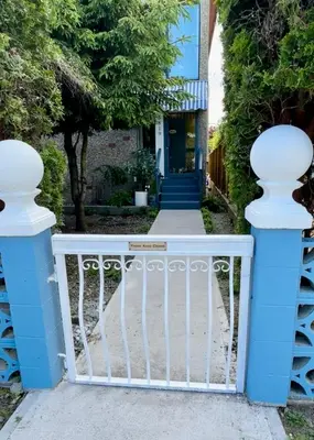 a blue and white gate in front of a house at Good Old Days Main Retro in Vancouver